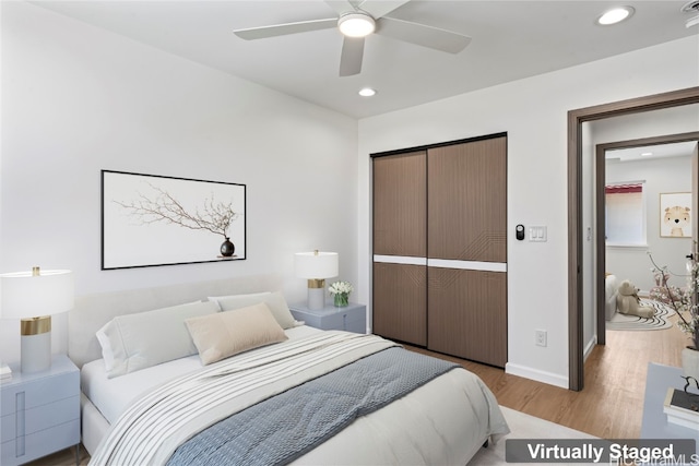 bedroom with a closet, ceiling fan, and light wood-type flooring