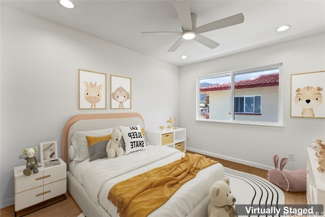 bedroom with hardwood / wood-style floors and ceiling fan