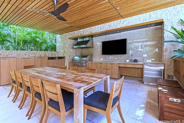 view of patio with area for grilling, ceiling fan, an outdoor wet bar, and grilling area