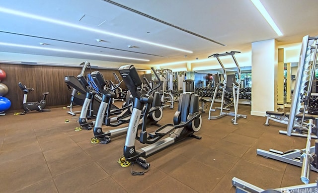 exercise room with wood walls