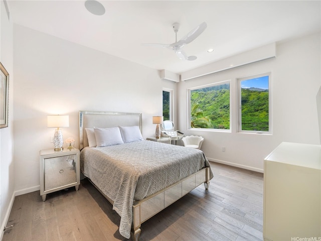 bedroom featuring wood finished floors, recessed lighting, a ceiling fan, and baseboards