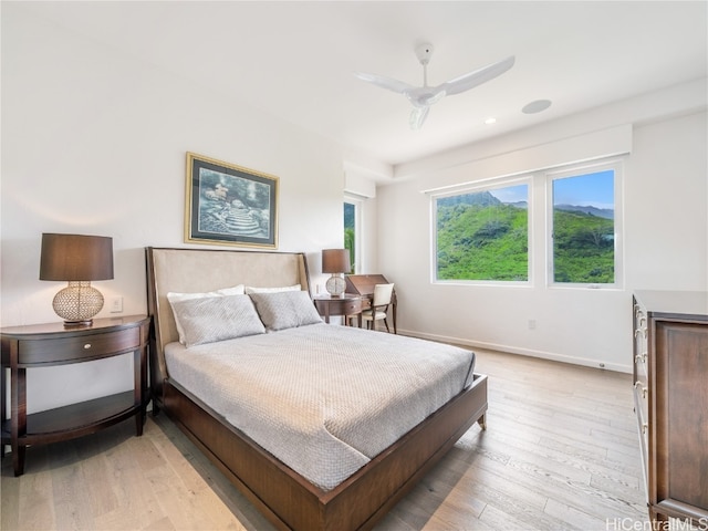 bedroom with light hardwood / wood-style floors and ceiling fan