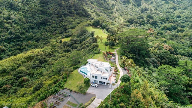 birds eye view of property with a wooded view