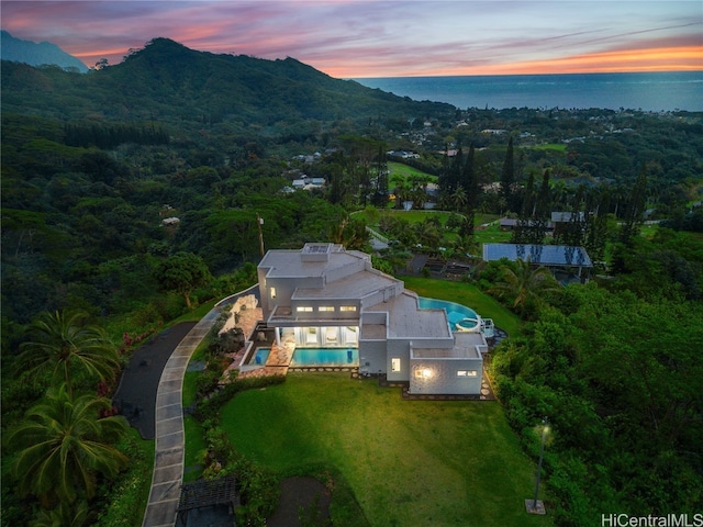 aerial view at dusk with a water and mountain view