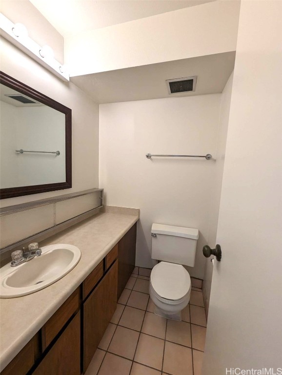 bathroom featuring vanity, toilet, and tile patterned floors