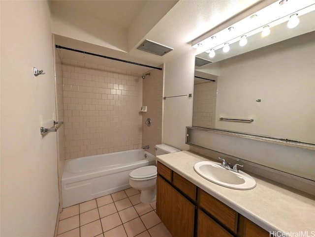 full bathroom with vanity, tiled shower / bath combo, toilet, and tile patterned flooring