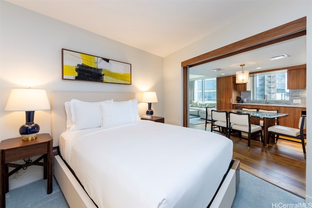 bedroom with sink and dark hardwood / wood-style flooring