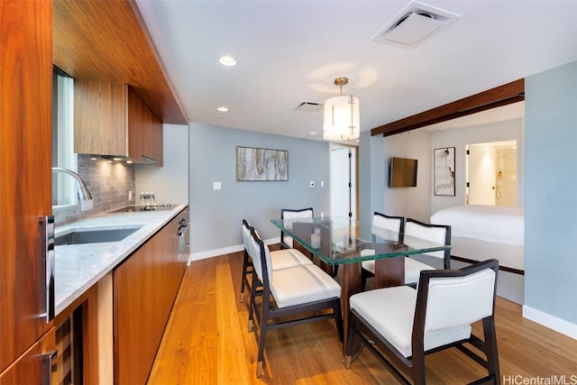 dining room featuring sink and light wood-type flooring