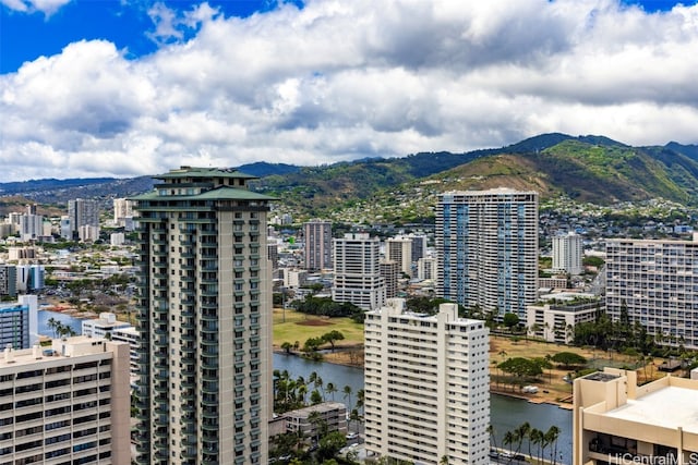 property's view of city with a water and mountain view