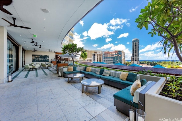 view of patio with an outdoor living space and ceiling fan