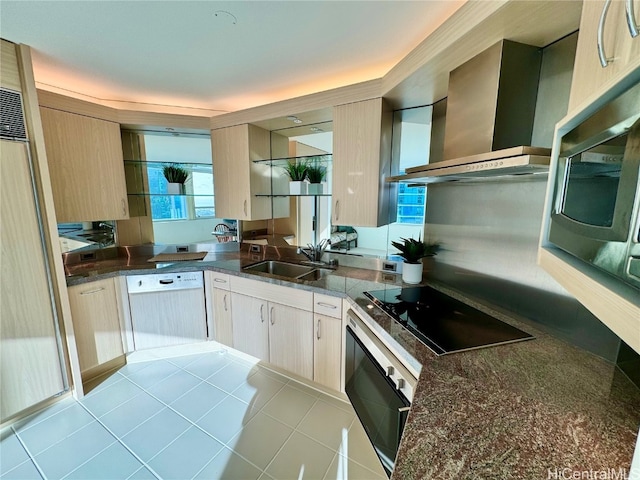 kitchen featuring wall chimney exhaust hood, appliances with stainless steel finishes, sink, and light brown cabinets