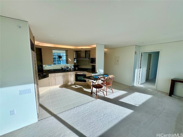 kitchen featuring light carpet, kitchen peninsula, black oven, and sink