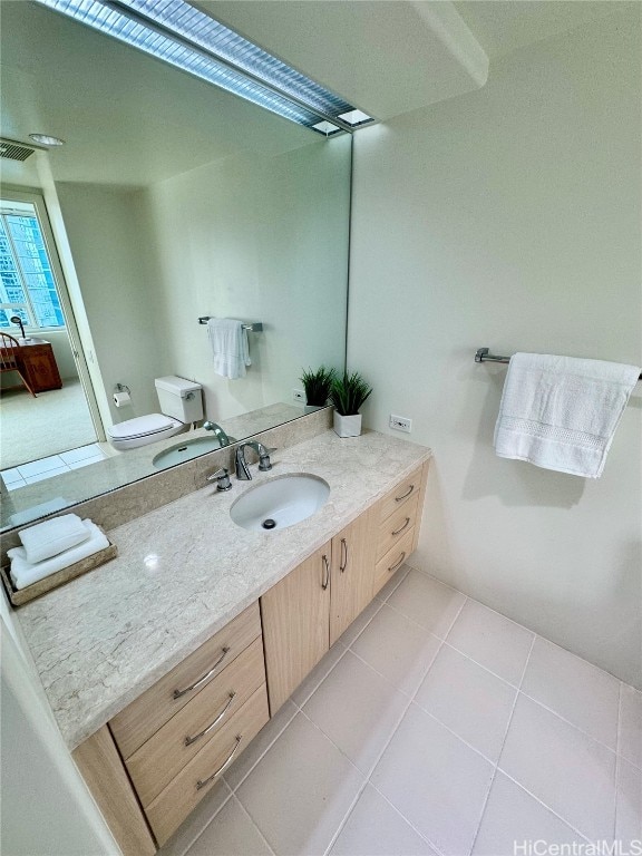 bathroom with vanity, toilet, and tile patterned floors