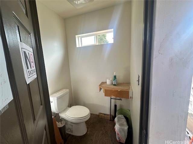 bathroom with toilet and wood-type flooring