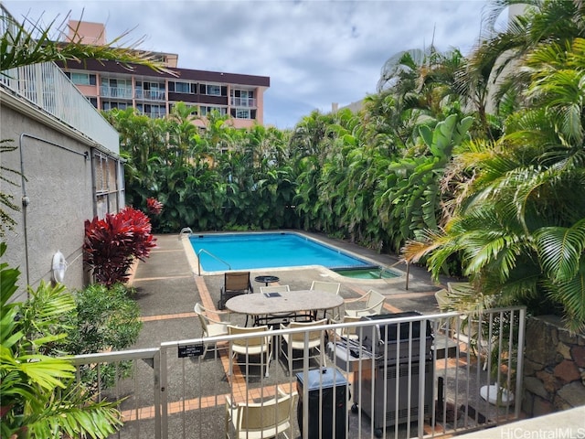 view of swimming pool featuring a patio area