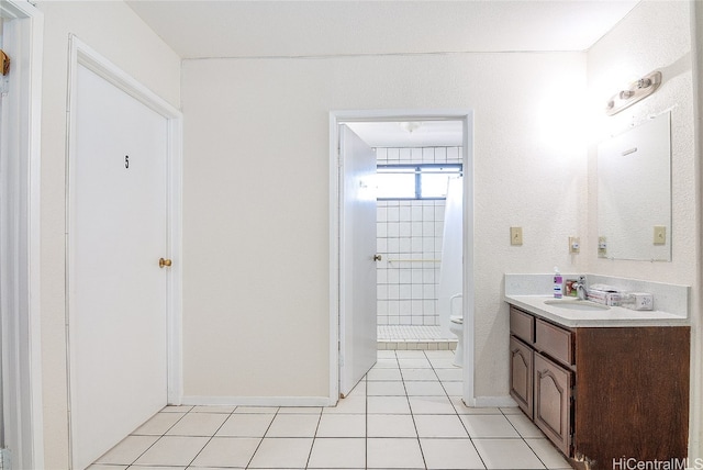 bathroom featuring vanity, toilet, and tile patterned flooring