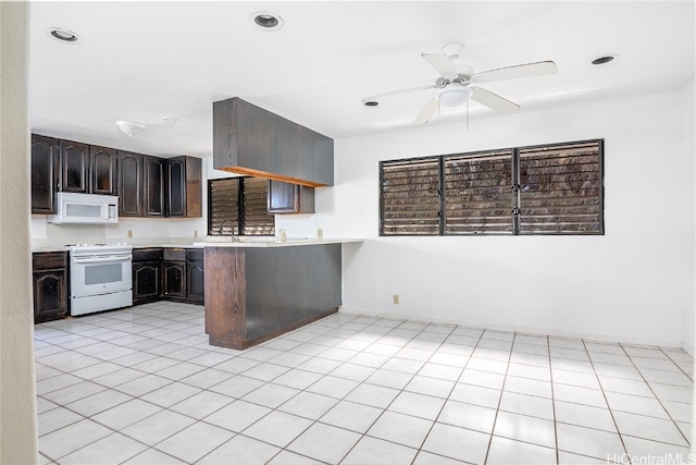 kitchen featuring white appliances, dark brown cabinets, kitchen peninsula, ceiling fan, and light tile patterned floors