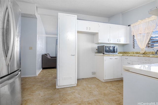 kitchen with sink, white cabinetry, and stainless steel appliances