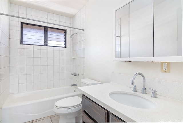 full bathroom featuring vanity, toilet, tile patterned floors, and tiled shower / bath combo