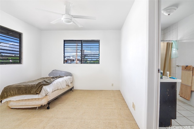 tiled bedroom featuring ceiling fan