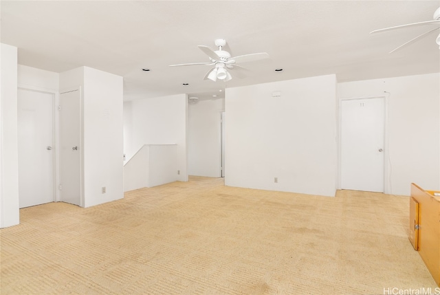 unfurnished room featuring light colored carpet and ceiling fan