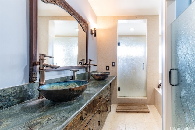 bathroom with vanity, a shower with shower door, and tile patterned flooring