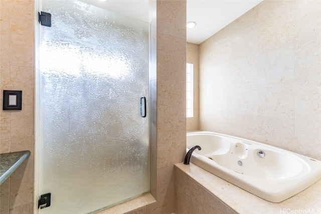 bathroom featuring shower with separate bathtub