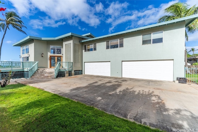 bi-level home with a front lawn and a garage