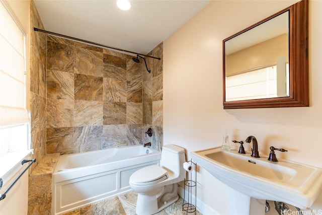 full bathroom featuring tiled shower / bath, sink, and toilet