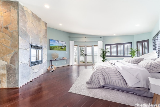 bedroom featuring french doors, dark wood-type flooring, and vaulted ceiling