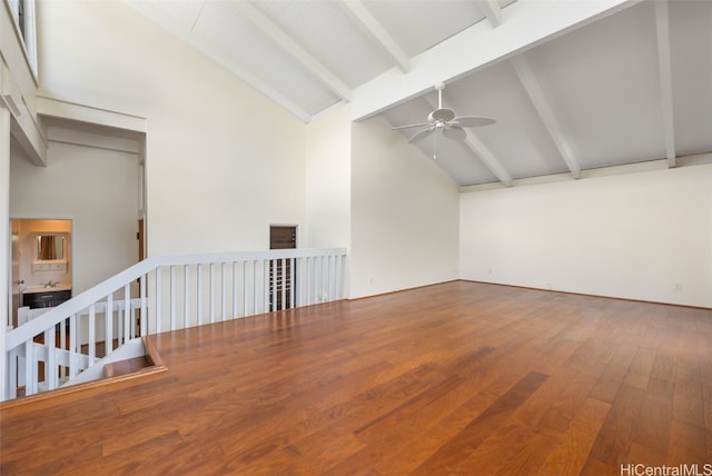 unfurnished living room with beamed ceiling, hardwood / wood-style flooring, high vaulted ceiling, and ceiling fan