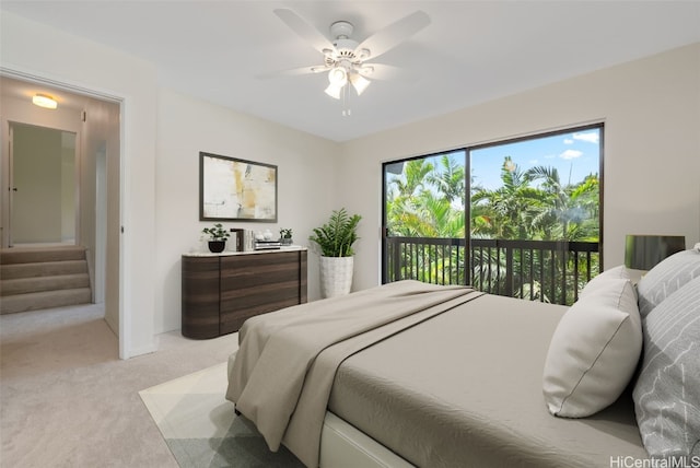 bedroom with access to outside, light colored carpet, and ceiling fan