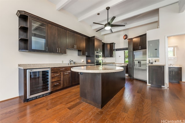 kitchen featuring stainless steel built in fridge, wine cooler, a wealth of natural light, and a kitchen island