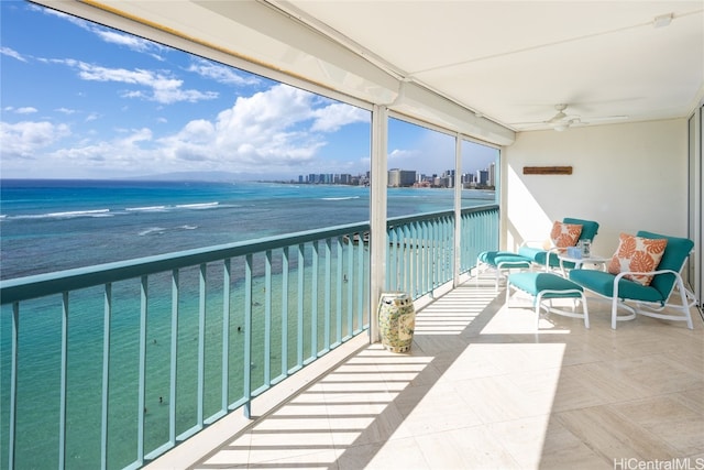 balcony featuring a water view and ceiling fan