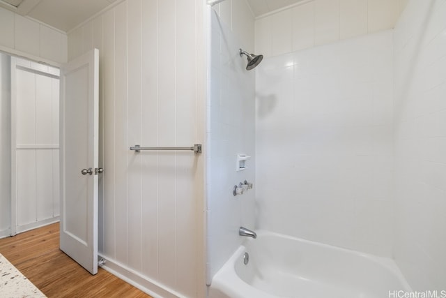 bathroom with tiled shower / bath and hardwood / wood-style floors