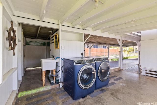 washroom featuring wood walls and separate washer and dryer