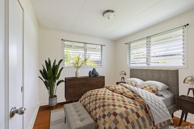 bedroom featuring dark wood-type flooring and multiple windows