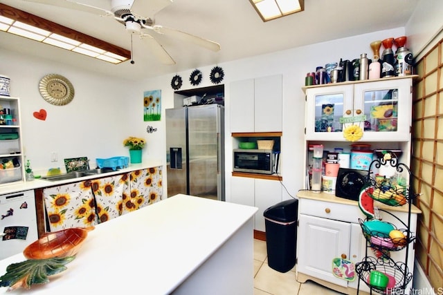 kitchen with white cabinetry, ceiling fan, appliances with stainless steel finishes, and light tile patterned floors