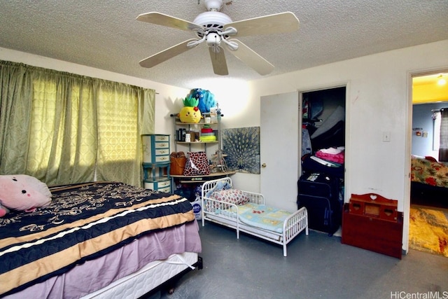 bedroom featuring a textured ceiling and ceiling fan