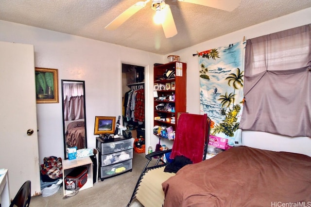 bedroom with a closet, ceiling fan, carpet flooring, and a textured ceiling