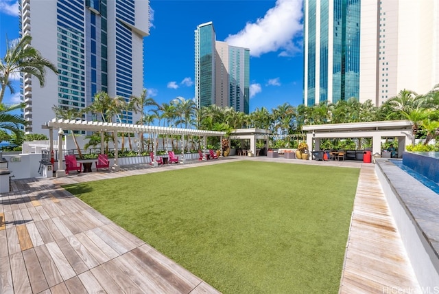 view of home's community featuring a lawn and a pergola