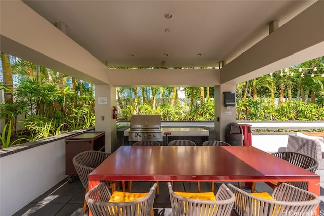 view of patio / terrace featuring exterior kitchen and a grill