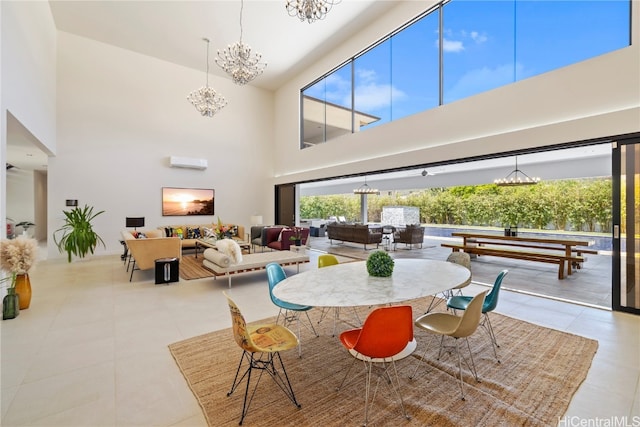 tiled dining area with an inviting chandelier, a wall mounted AC, and a high ceiling