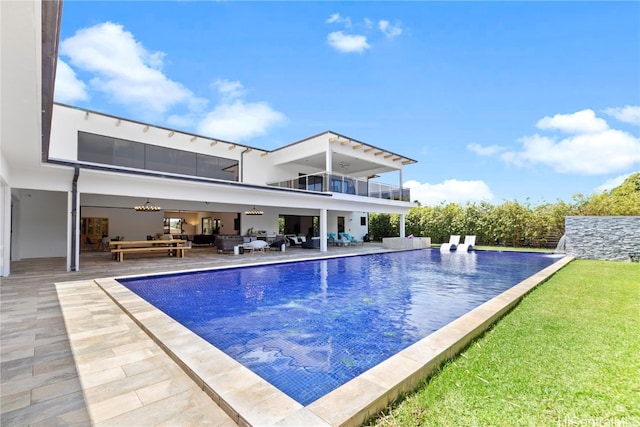 view of swimming pool featuring a patio, outdoor lounge area, and a yard