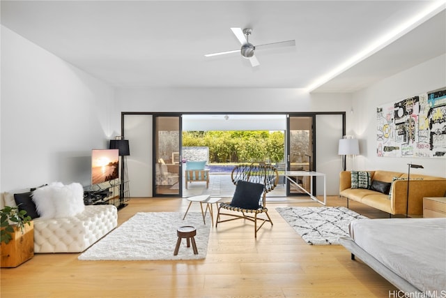 living room featuring hardwood / wood-style flooring and ceiling fan