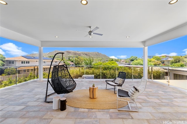 view of patio / terrace with a mountain view and ceiling fan