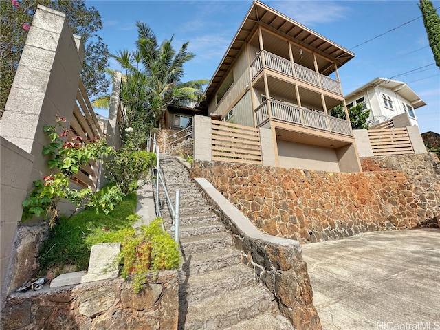 view of side of home featuring a balcony