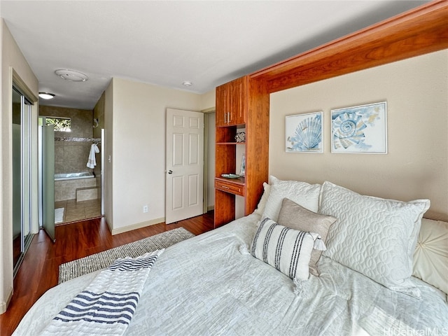 bedroom with dark hardwood / wood-style flooring