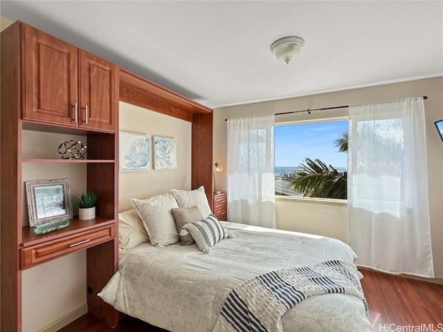 bedroom featuring dark hardwood / wood-style flooring