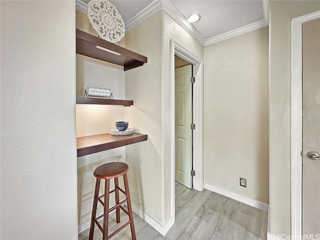 hallway with crown molding and light hardwood / wood-style floors